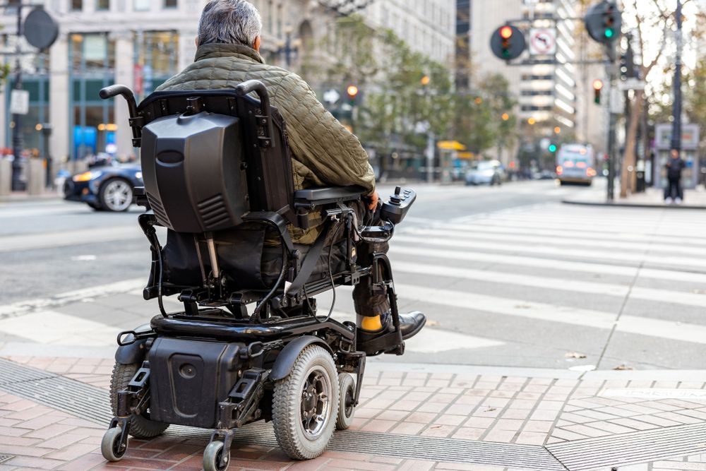 man driving electric wheelchair