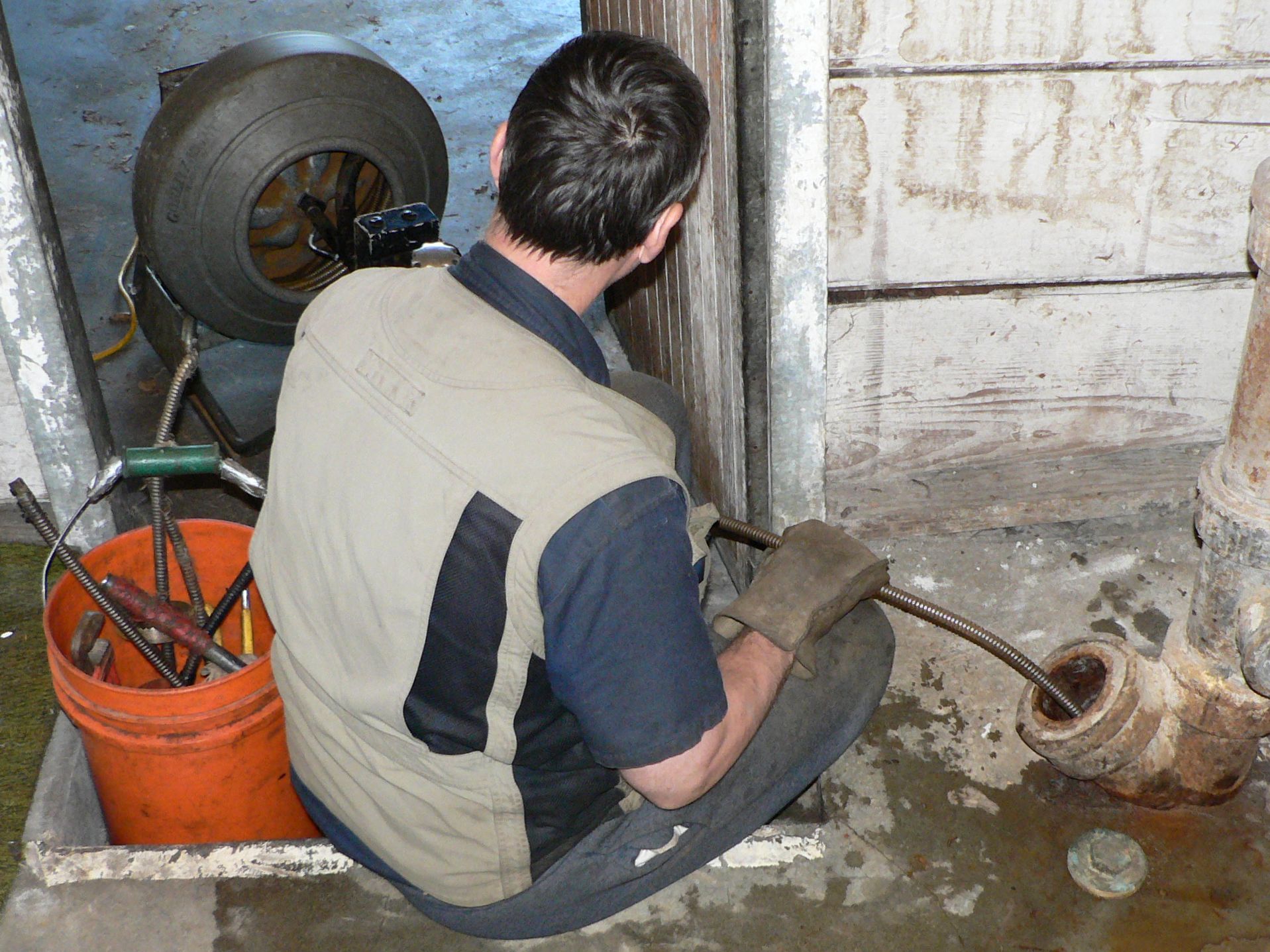 A plumber trying to unclogged drainage pipe